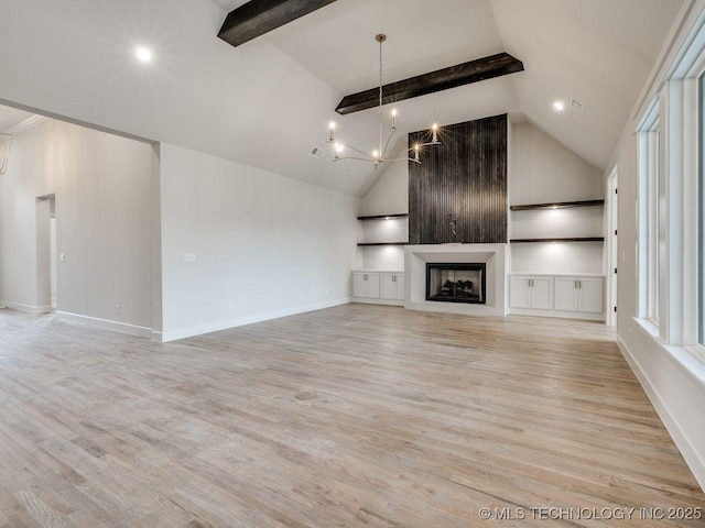 unfurnished living room featuring light hardwood / wood-style flooring, an inviting chandelier, vaulted ceiling with beams, a fireplace, and built in shelves