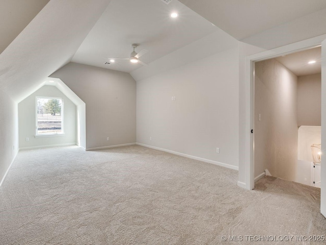 additional living space featuring lofted ceiling, light colored carpet, and ceiling fan