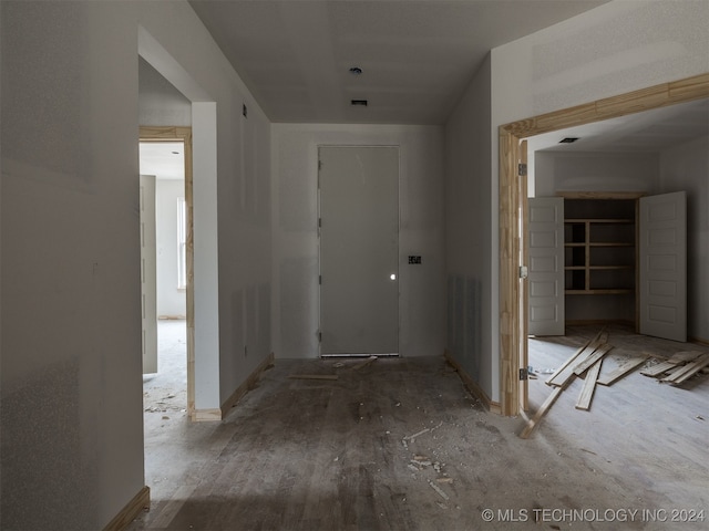 hall with hardwood / wood-style floors