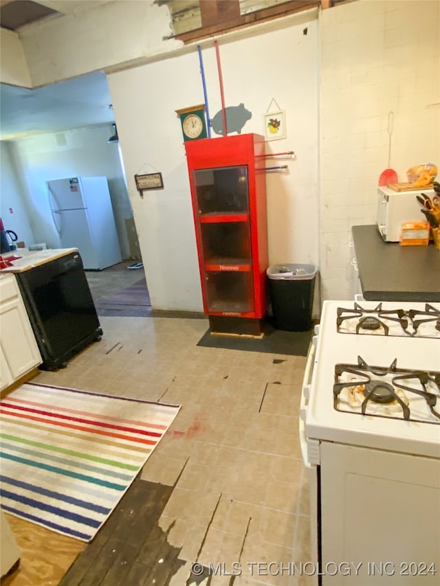 kitchen featuring white cabinets and white appliances