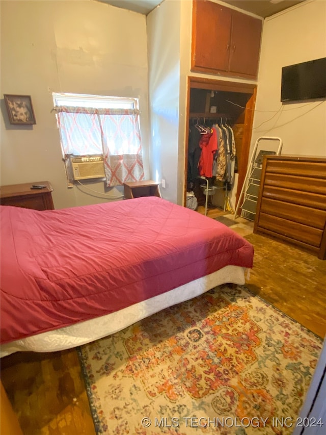 bedroom with hardwood / wood-style floors and a closet