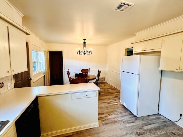 kitchen with dishwasher, a notable chandelier, white fridge, decorative light fixtures, and light wood-type flooring