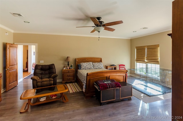 bedroom featuring ceiling fan, dark hardwood / wood-style floors, and ornamental molding