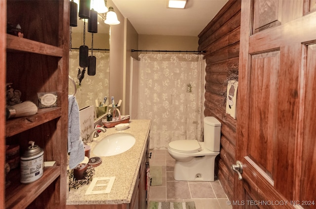 bathroom featuring tile patterned floors, vanity, toilet, and walk in shower