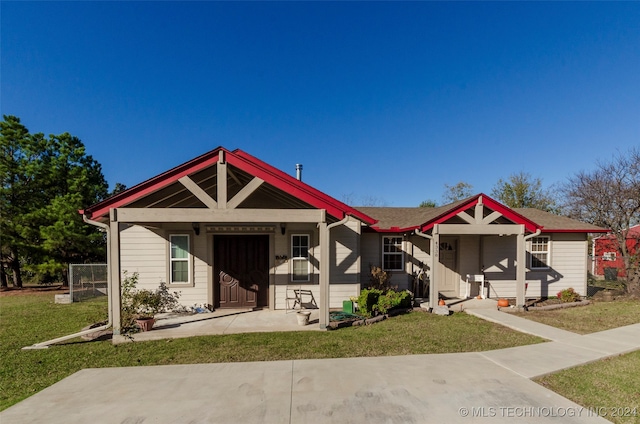 bungalow-style home featuring a front yard