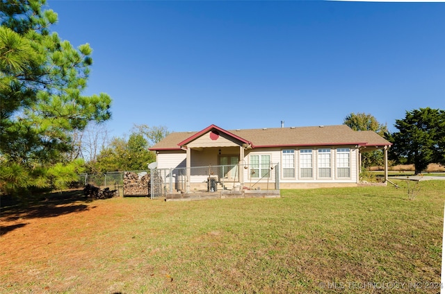 rear view of house featuring a yard