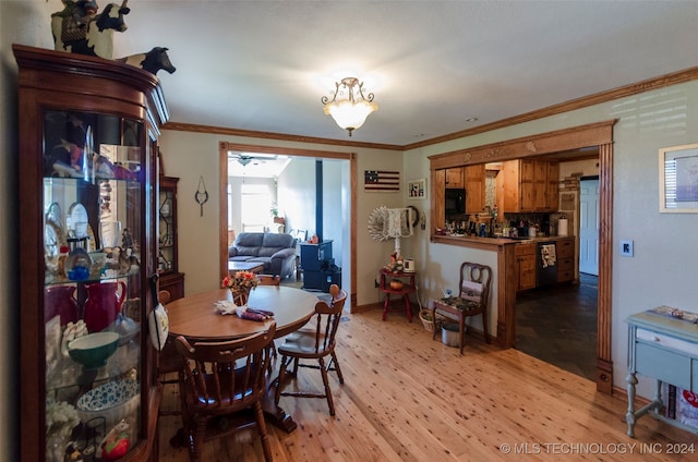 dining room featuring light hardwood / wood-style flooring and ornamental molding