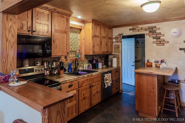 kitchen featuring wooden counters, a kitchen breakfast bar, sink, ornamental molding, and stainless steel appliances