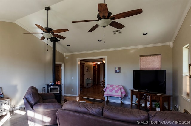 living room featuring a wood stove, crown molding, ceiling fan, and lofted ceiling