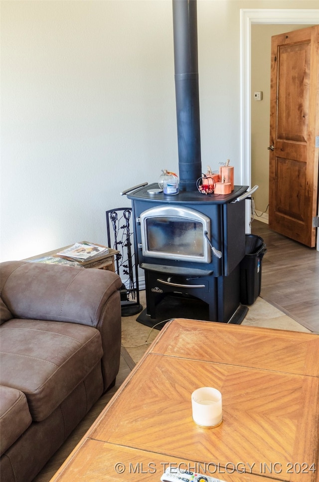 details with hardwood / wood-style flooring and a wood stove