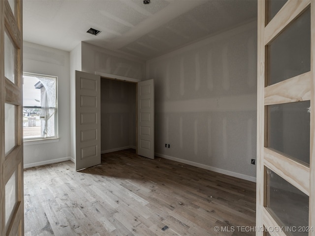 unfurnished bedroom with light wood-type flooring