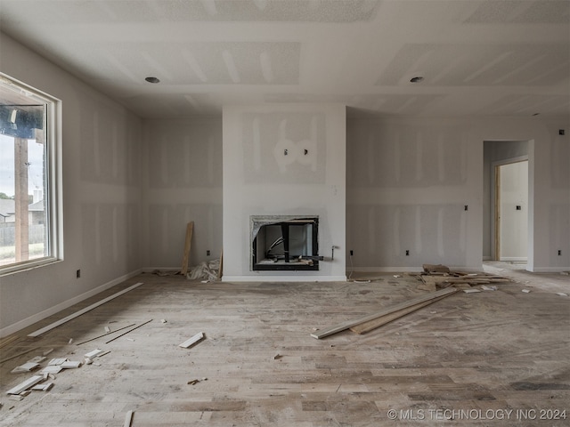 unfurnished living room featuring hardwood / wood-style flooring