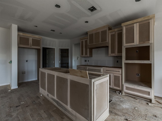 kitchen featuring a kitchen island and hardwood / wood-style flooring