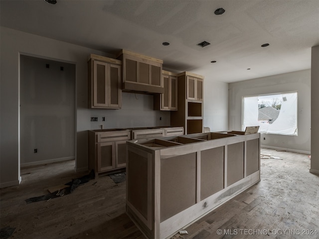 kitchen featuring hardwood / wood-style floors and a kitchen island