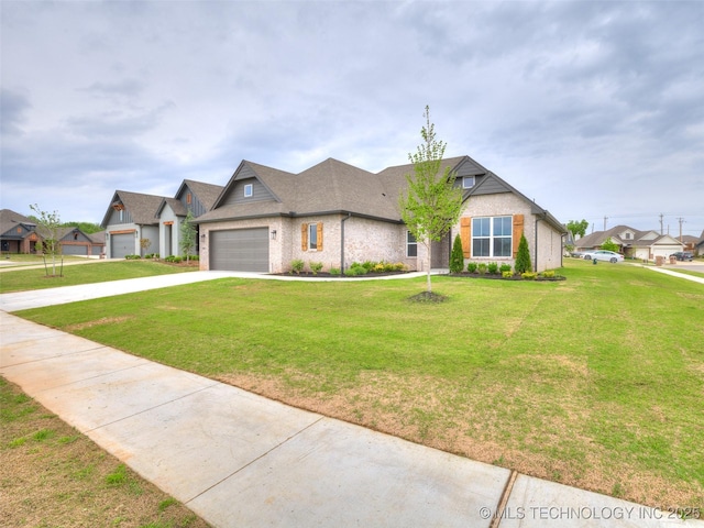 view of front of home featuring an attached garage, driveway, a front lawn, and a residential view