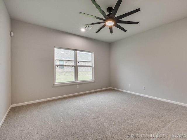 unfurnished room featuring ceiling fan, carpet floors, visible vents, and baseboards