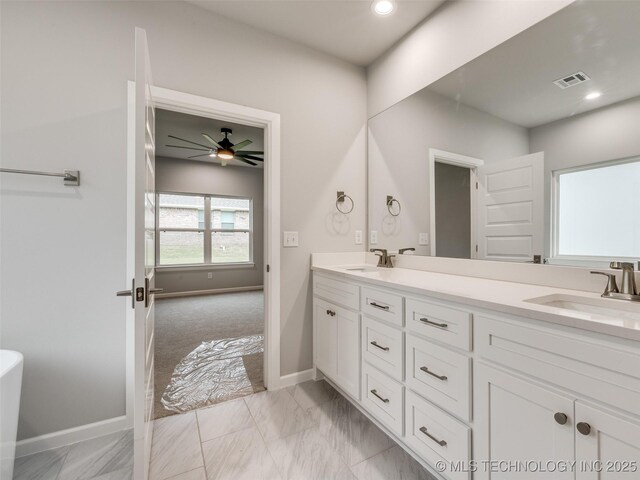 bathroom featuring visible vents, a sink, marble finish floor, and double vanity