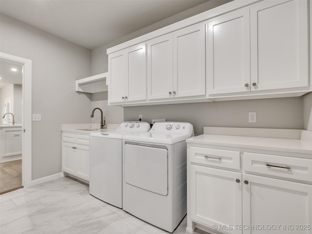 laundry area with separate washer and dryer, cabinet space, marble finish floor, and a sink