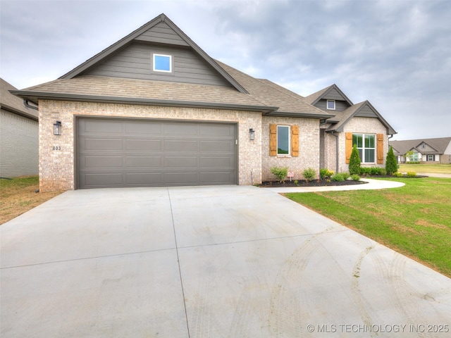 craftsman house with an attached garage, driveway, roof with shingles, and a front yard
