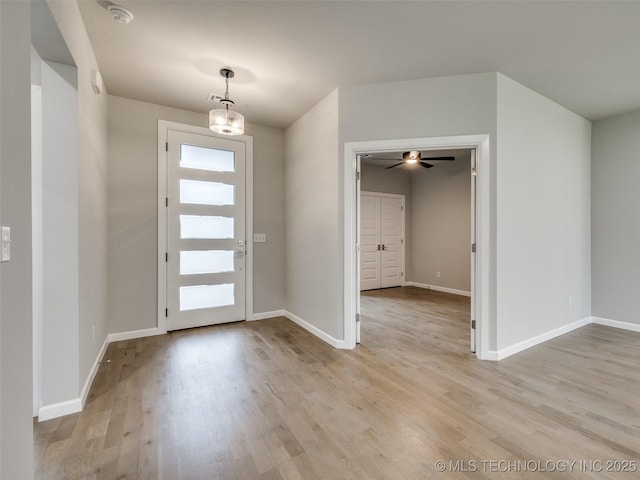 entryway with light wood-type flooring and baseboards