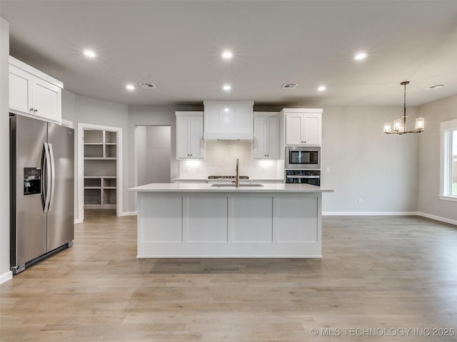kitchen with built in microwave, white cabinets, oven, stainless steel fridge with ice dispenser, and visible vents
