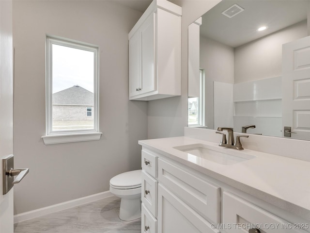 bathroom featuring toilet, plenty of natural light, visible vents, marble finish floor, and vanity