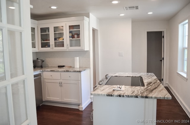 kitchen featuring backsplash, white cabinetry, dark hardwood / wood-style flooring, and light stone counters