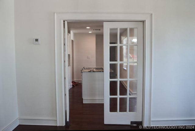 hall with dark wood-type flooring