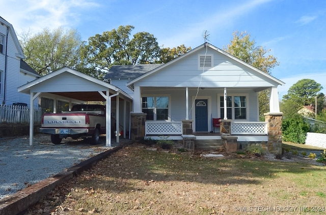 view of front of house with a carport and a porch