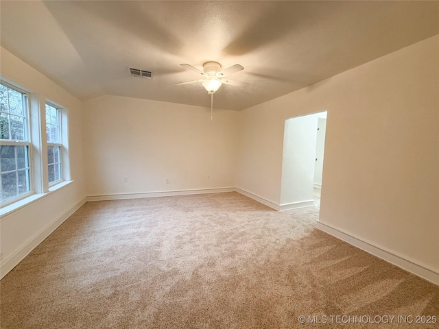 carpeted spare room featuring ceiling fan