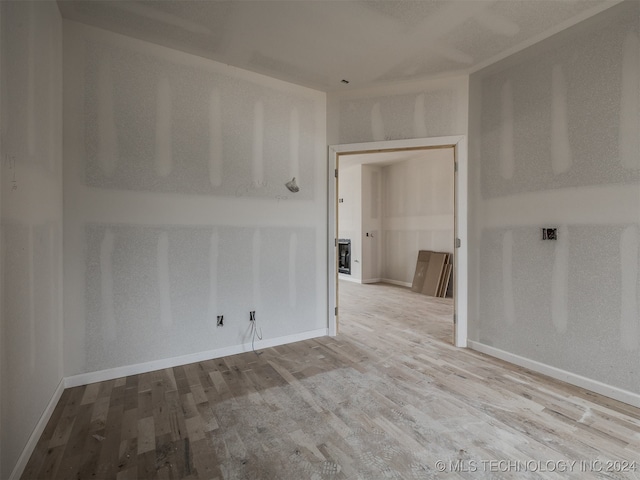 unfurnished room with light wood-type flooring