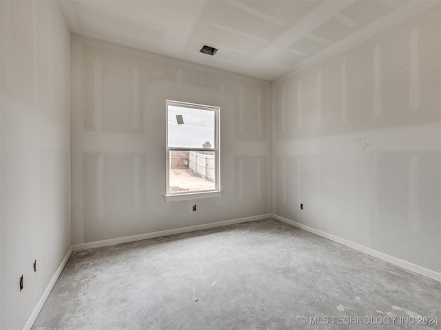 unfurnished room with concrete floors