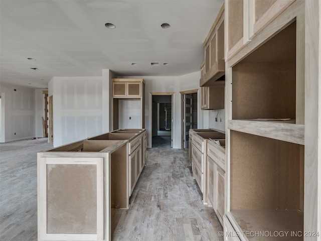 kitchen with light brown cabinets and light hardwood / wood-style flooring