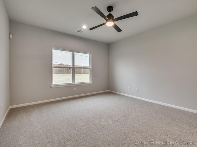 spare room with ceiling fan, baseboards, visible vents, and carpet