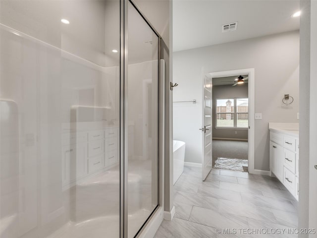 full bath featuring a stall shower, vanity, a soaking tub, baseboards, and visible vents