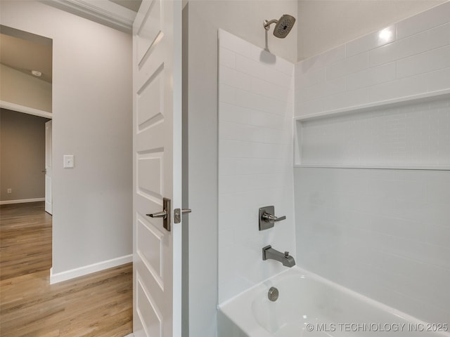 full bathroom featuring bathtub / shower combination, baseboards, and wood finished floors