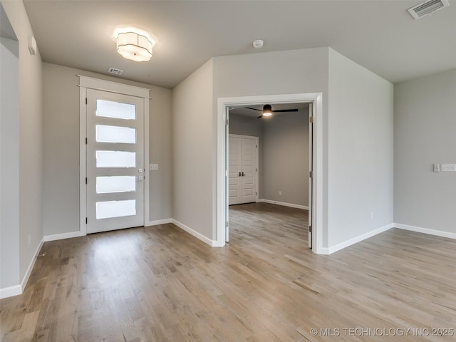 foyer featuring light wood-style floors, visible vents, and baseboards