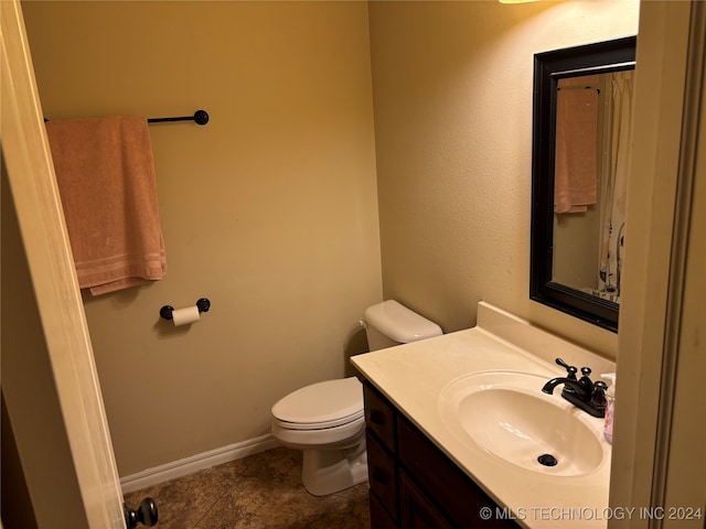 bathroom with tile patterned floors, vanity, and toilet