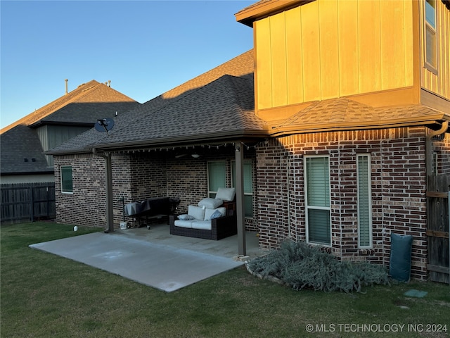 rear view of house with a yard and a patio