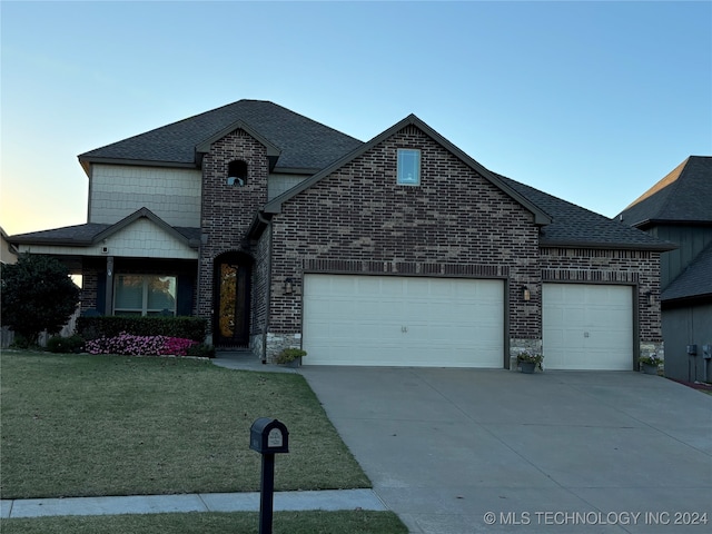 view of front of property featuring a yard and a garage