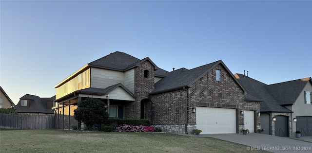 view of front facade with a front yard and a garage