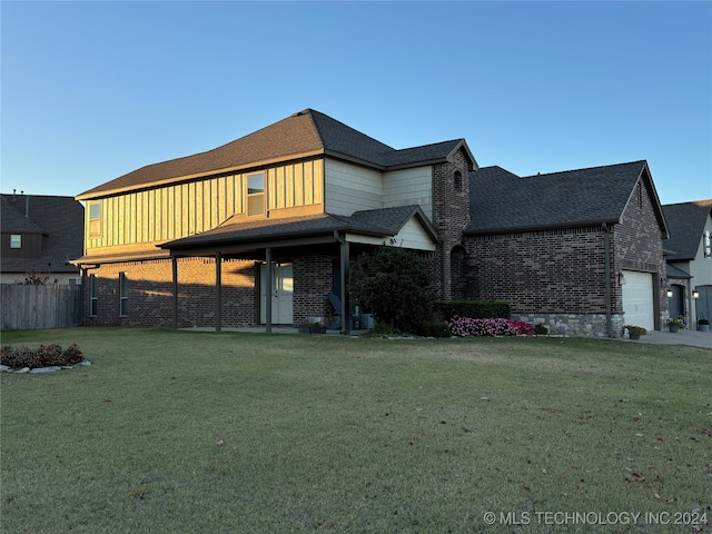 view of front of property with a front yard and a garage