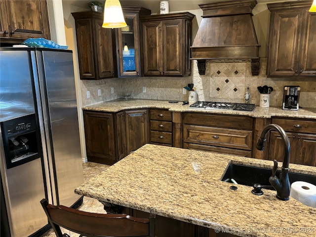 kitchen with custom range hood, stainless steel appliances, and dark brown cabinets