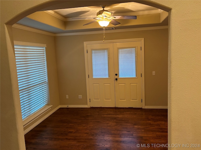 foyer with a tray ceiling, ceiling fan, dark hardwood / wood-style floors, and ornamental molding