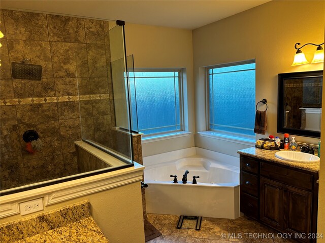 bathroom with vanity and plus walk in shower