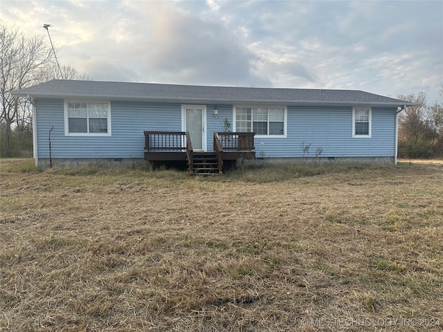 exterior space with a deck and a front lawn