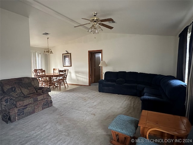 carpeted living room featuring ceiling fan with notable chandelier and vaulted ceiling