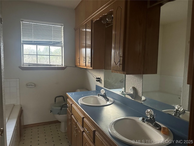 full bathroom featuring a tub, a sink, and toilet