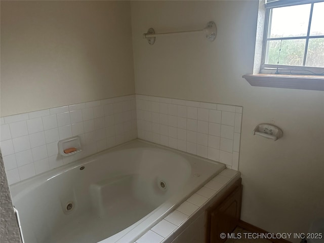 bathroom featuring a tub with jets