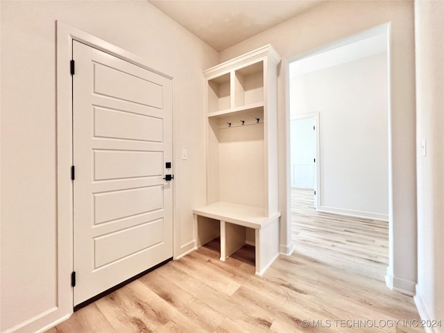 mudroom featuring light wood-style floors and baseboards